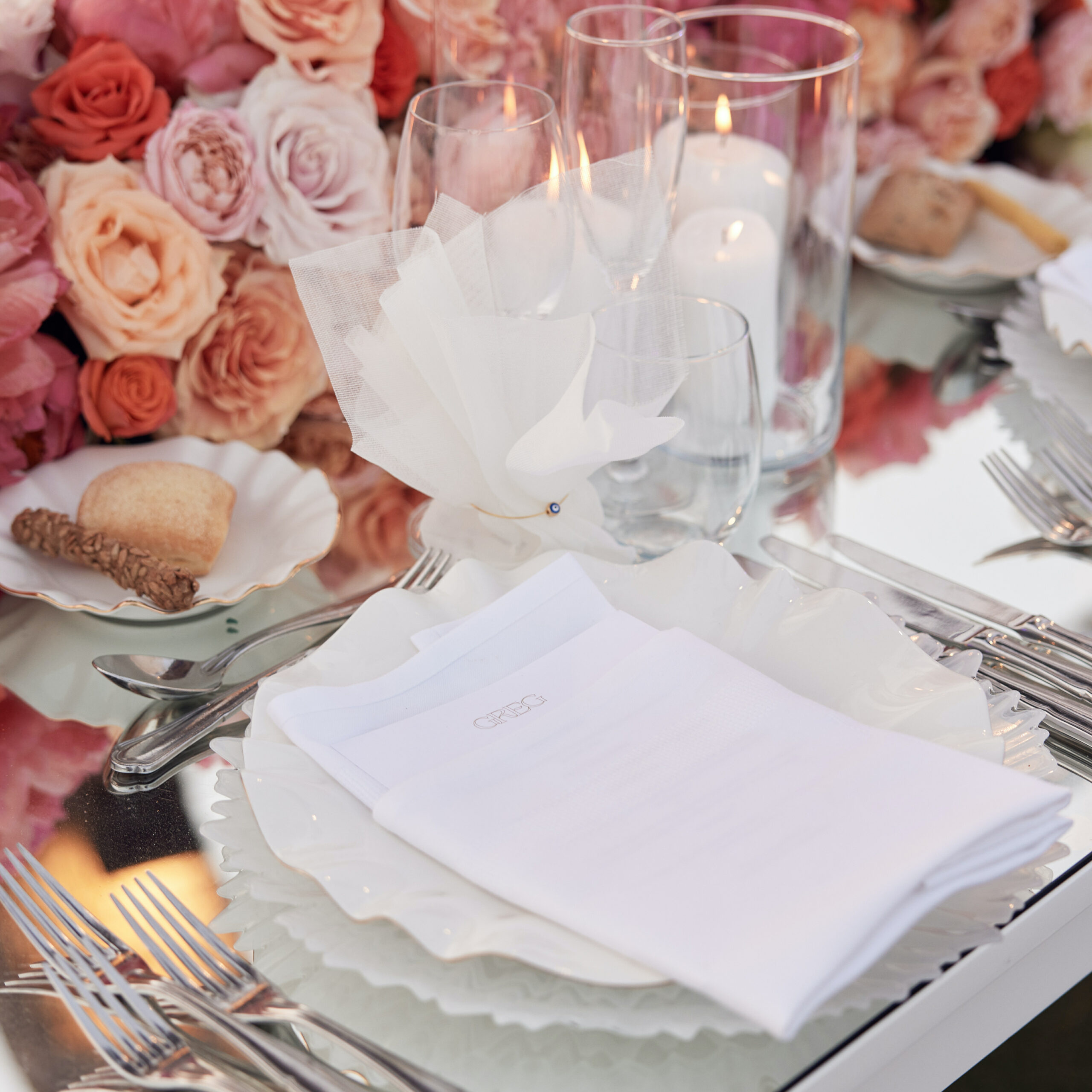 symphony-of-romance-wedding-reception-shades-of-pink-and-peach-linen-favors-with-evil-eye-main-photo